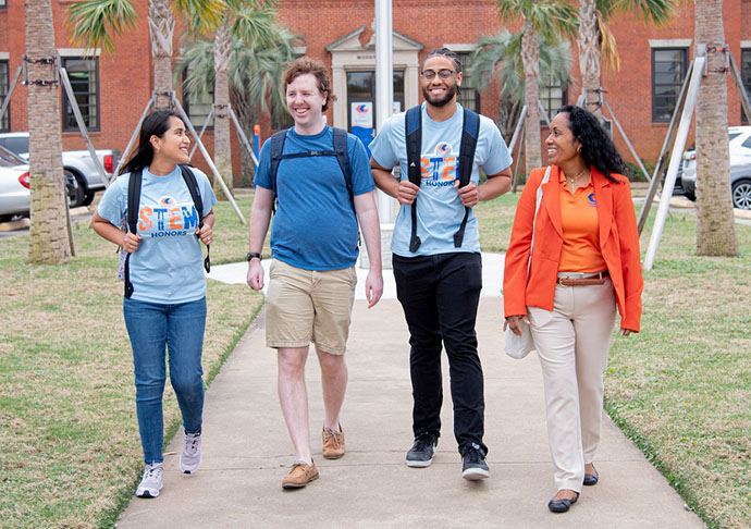 4 students walking on campus