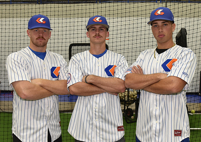 Three baseball players pose for photo.
