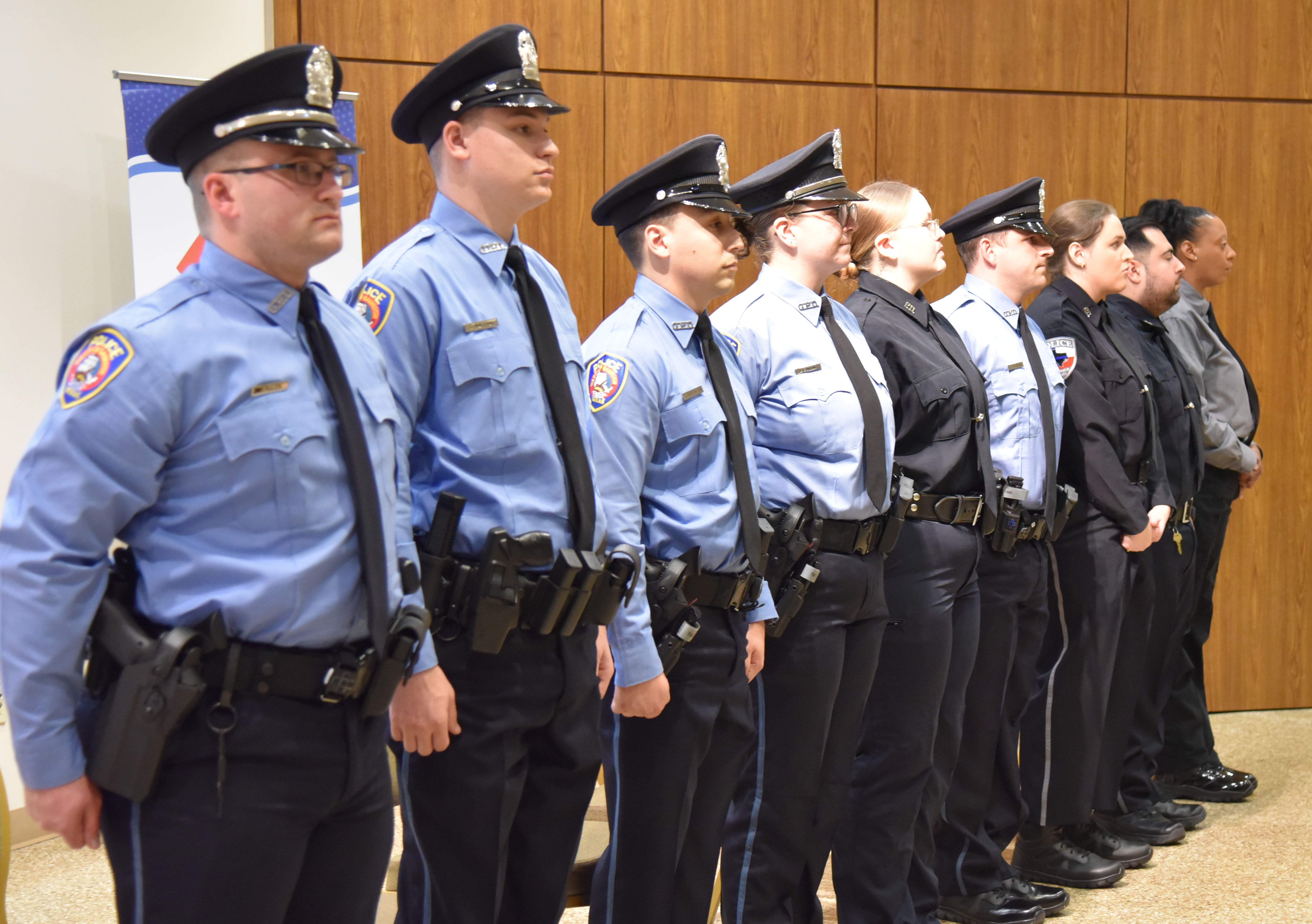Students of the law enforcement program stand at attention at their graduation