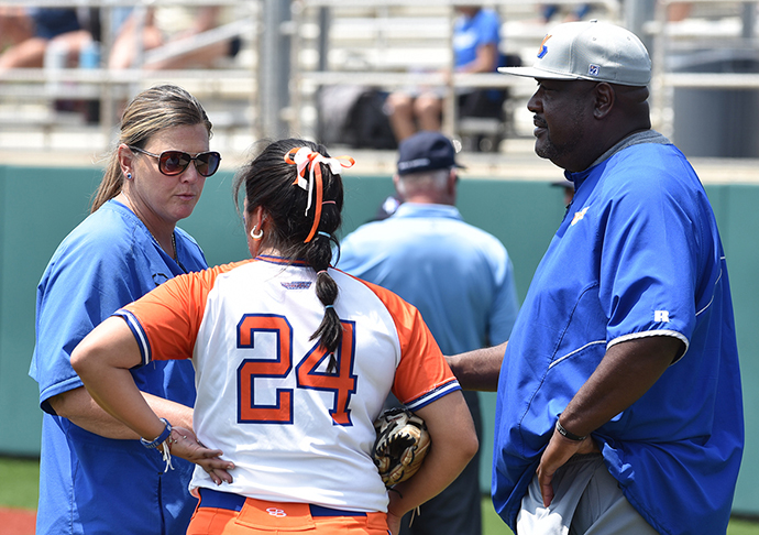 Galveston coaches talk to softball player.