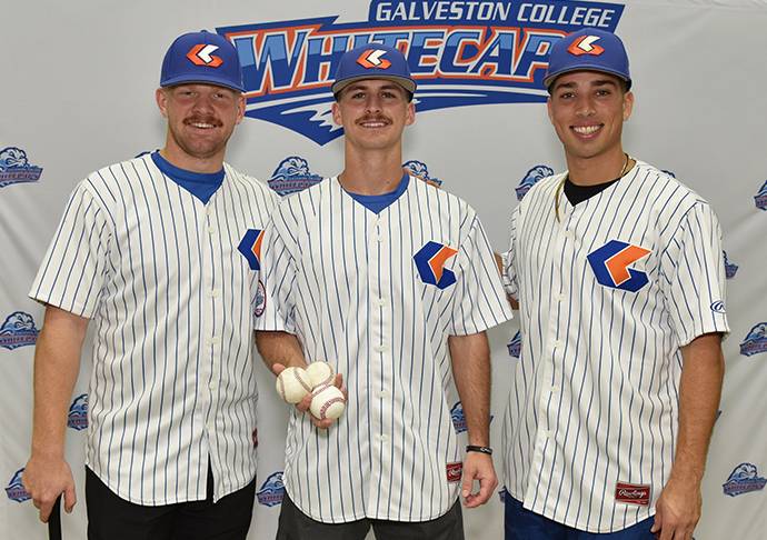Three baseball players pose for photo.