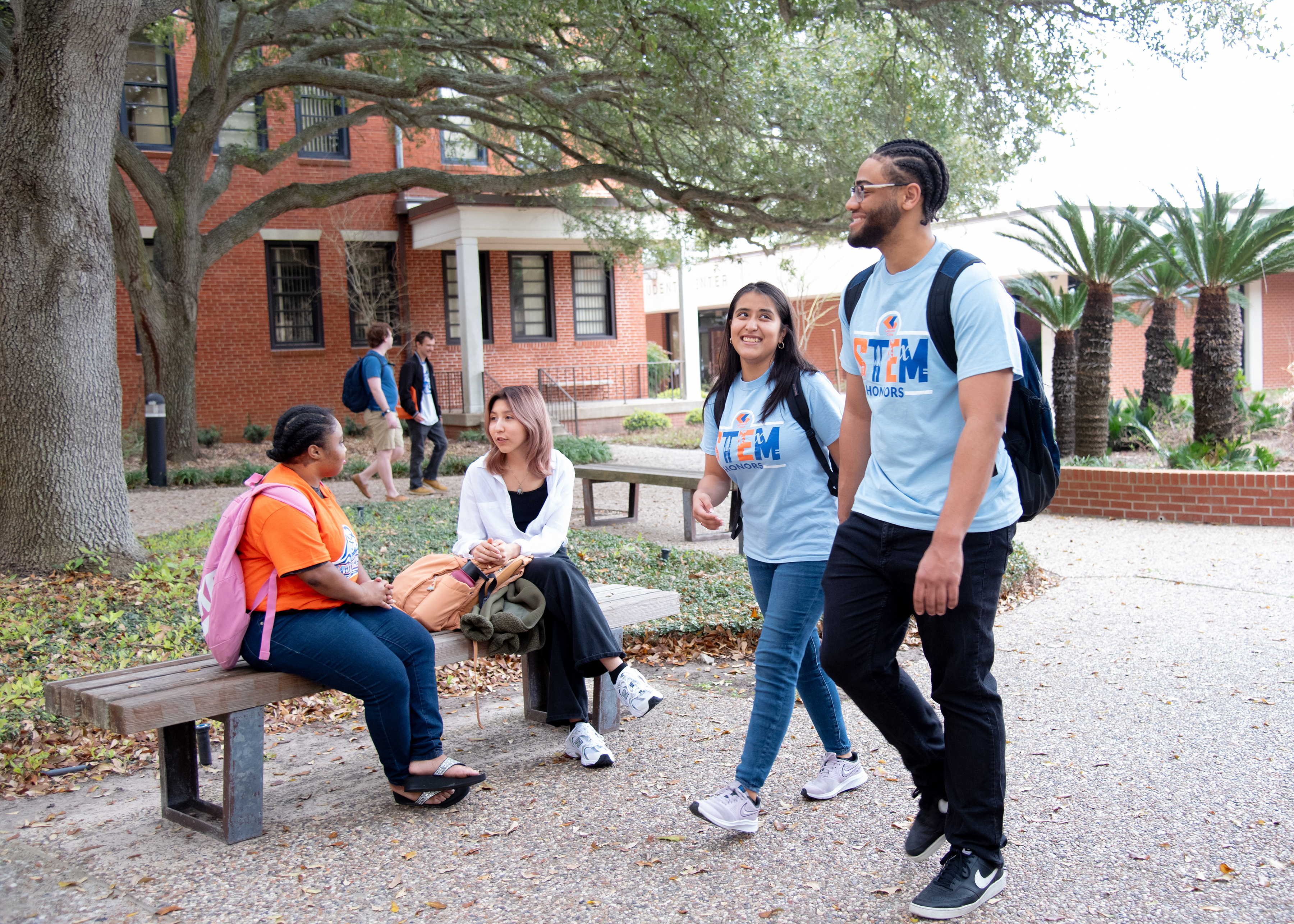 A student and an advisor sit an a desk for registration 