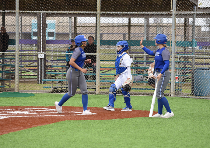 Galveston College sophomore outfielder Kamyrn Cottrell high-fives freshman infielder Amaya Foxover after hitting a homerun against Monroe College in the second game of a doubleheader on Feb. 15, 2023 at the Lassie League Complex in Galveston.